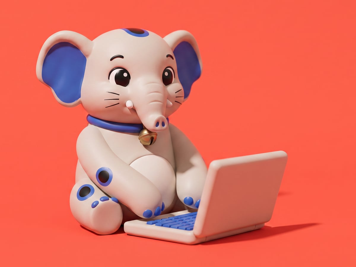 The Cornelius figurine sitting at a small laptop, both paws on the keyboard